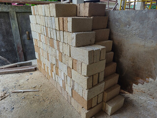 Rectangular solid white and gray bricks are neatly arranged in the warehouse.