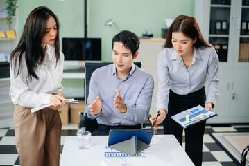 Happy businesspeople while collaborating on a new project in an office. Group of diverse businesspeople using a laptop and tablet