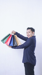 Portrait of Asian man carrying many shopping bags isolated on white background