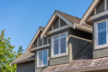 Top of luxury house with shingle roof and nice windows in Summer in Vancouver, Canada, North America. Day time on July 2025.
