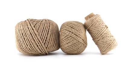 Close-up of three different sized spools of natural twine on a pure white background.