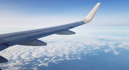 Airplane wing over a vast expanse of clouds.