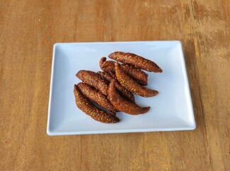 fried chicken wings,Deppa tori or Deppa Te'tekan or Beppa tori or Cucuru or Cicuru or Kue cucur is a authentic snack from Tana Toraja regency  South Sulawesi.It made from rice flour,palm sugar and ses