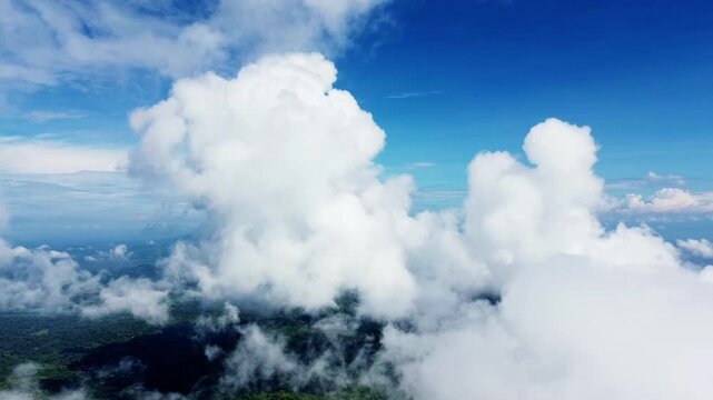 An aerial view of a clear sky with fluffy white clouds above mist-shrouded mountains with clear blue sky in Sukoharjo, Central Java, Indonesia, on Sunday, June 8, 2025.