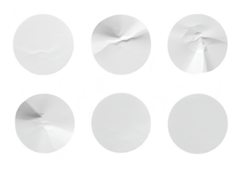 A collection of six circular stickers some with crumpled texture isolated on a transparent background