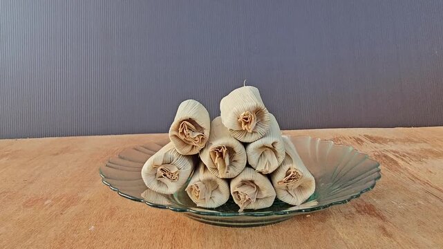 handmade soap on a wooden background,Baje' or Bajek or Wajek is a authentic cake from Bugis ethnic and Mandar in Sulawesi,made from glutinous rice and palm sugar,wrapped in dried banana leaves.