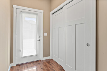 White door with a window in front of a white closet