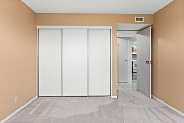 White room with a white closet and a white door