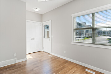 White room with a window and a door