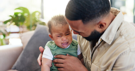 Sofa, father and comfort crying baby with bonding together, frustrated and discomfort with teething. Single dad, people and console sad infant in home with attention, parenting and child development