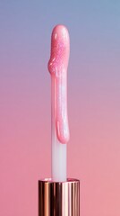 Close up of a shimmering pink lip gloss wand with a gradient pink and purple background