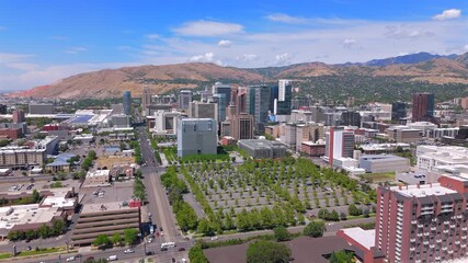 An aerial view of Salt Lake Citys colorful skyline, set against majestic mountains and lush greenery, enhances its charm, making it a delightful travel destination worth exploring