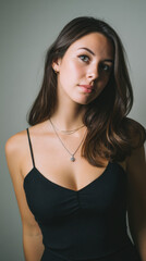 Naklejka premium Portrait of a young woman radiating confidence in a minimalist studio. 