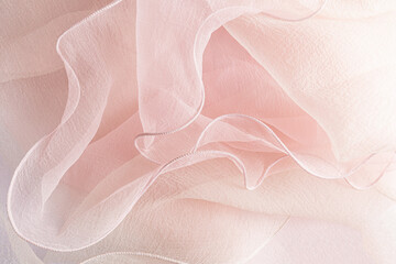 Stylish pink transparent background of delicate ruffles of the bride's dress. soft waves of silk...