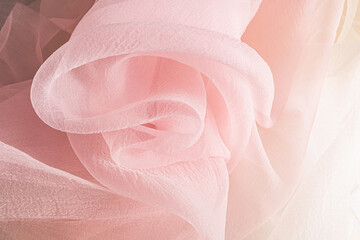 chic large waves of pink chiffon fabric. Delicate transparent fabric texture. elegantly twisted...