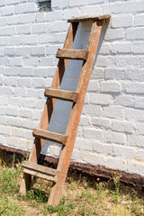 A wooden staircase against the wall of a rural house. An old wooden staircase.