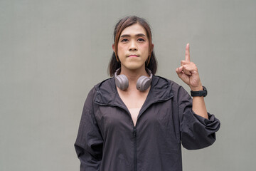 Portrait of a non binary transgender Asian woman pointing finger