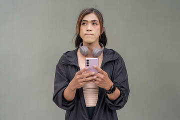 Portrait of a non binary transgender Asian woman using phone