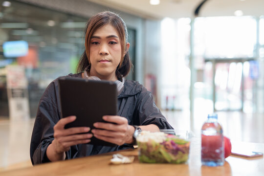 Transgender non binary woman eating healthy salad in restaurant