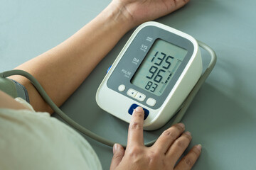 Man check blood pressure monitor and heart rate monitor with digital pressure gauge. Health care and Medical concept	
