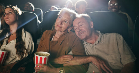 Senior couple, popcorn and sleep at movie theater with smile in crowd, bonding and show on date. Elderly people, relax together and love with fast food, snack and care with film screening at cinema