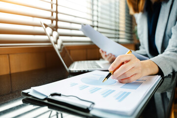 Confident businessman working on laptop, tablet and smartphone at her workplace at office.