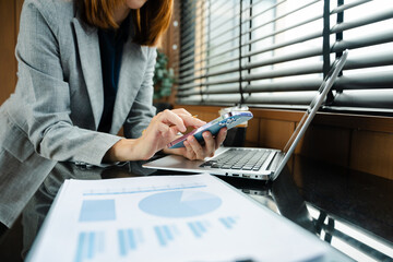 Confident businessman working on laptop, tablet and smartphone at her workplace at office.