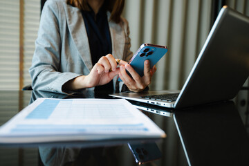 Confident businessman working on laptop, tablet and smartphone at her workplace at office.