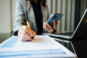 Businesswoman hand working digital marketing media in virtual screen with mobile phone and modern...