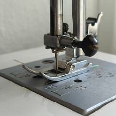 Metal sewing machine foot close-up. Atelier, clothing industry