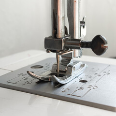 Metal sewing machine foot close-up. Atelier, clothing industry