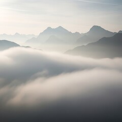 Obraz premium Misty mountain range veiled in soft clouds.