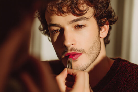 man applying red lipstick in front of a mirror - Powered by Adobe
