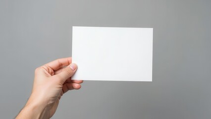 Obraz premium hand holding a blank white paper