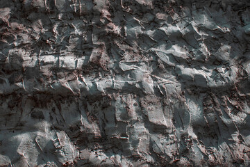 A fragment of a concrete wall in close-up on a summer day