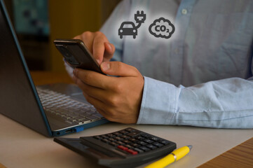 Businessman using smartphone and laptop in office. Man scrolls social media, checks email, manages...