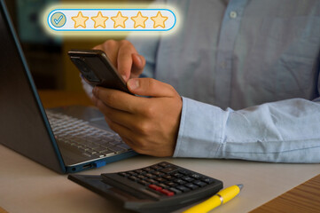 Businessman using smartphone and laptop in office. Man scrolls social media, checks email, manages...