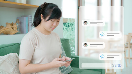 Young Asian woman sits on a couch using her smartphone, engaging in a conversation with an AI...