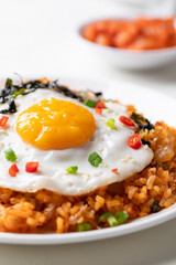 Korean kimchi fried rice with fried egg, pork, sesame seed, chili, spring onion and seaweed 