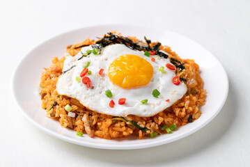 Korean kimchi fried rice with fried egg, pork, sesame seed, chili, spring onion and seaweed 