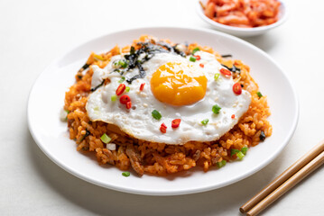 Korean kimchi fried rice with fried egg, pork, sesame seed, chili, spring onion and seaweed 