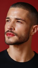 Obraz premium Portrait of a European Man with Lipstick Stains Against a Red Background