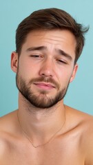 Obraz premium Portrait of a Young Man with Kiss Marks on His Face Against a Light Blue Background