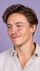 Fototapeta premium Portrait of a Young Man with Lipstick Stains on His Face Against a Purple Background