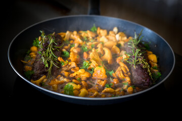 healthy lifestyle - roasted chanterelles and filet from venison with fresh herbs out the garden 