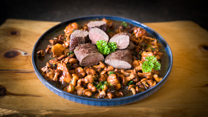 roasted chanterelles and filet from venison with fresh herbs out the garden 