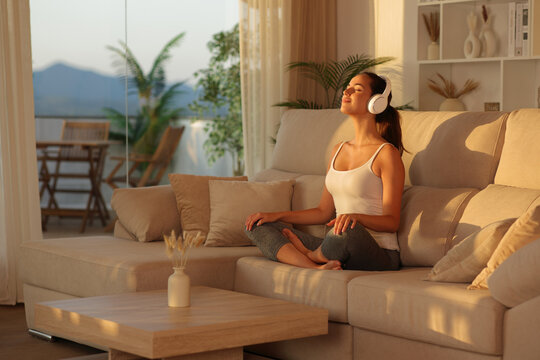 Yogi doing meditation with headphone at home