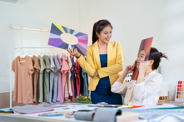 Young Asian woman doing personal color diagnosis by Face frames Color Season Kit for determining...