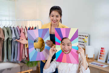 Young Asian woman doing personal color diagnosis by Face frames Color Season Kit for determining...