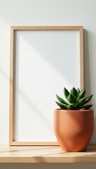 Framed succulent in handcrafted terracotta pot, light Scandinavian setting , green, neutral